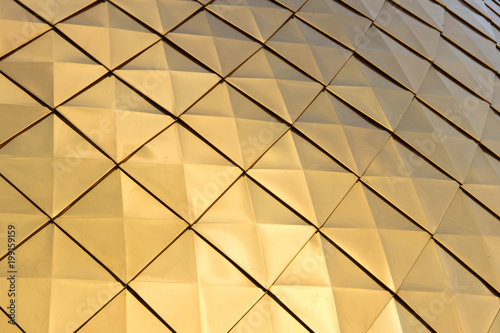 Close up shot of a golden dome of a church, cathedral or mosque. Background metal yellow rectangle pattern