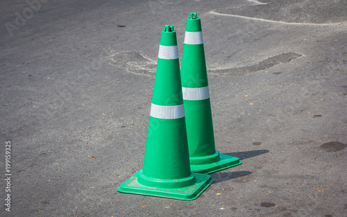 Green traffic cones laid on the road