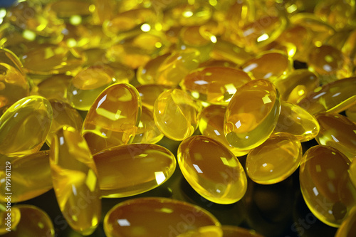 3D Rendering Fish Oil. Omega 3, omega 6, omega 9, vitamin D. Pile of capsules Omega 3 on black background, Cod Liver