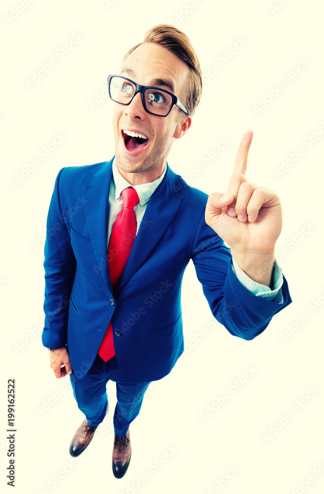 Happy businessman showing up by index finger Happy businessman showing up by index finger