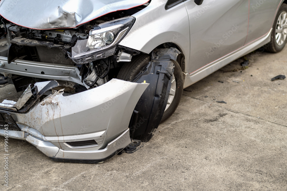 closeup car in front has been damaged by accident with soft-focus and over light in the background closeup car in front has been damaged by accident with soft-focus and over light in the background
