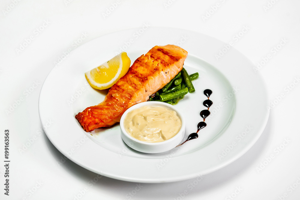 fried fish on a plate with herbs sauce and lemon fried fish on a plate with herbs sauce and lemon