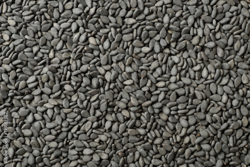 food background of black sesame seeds, top view