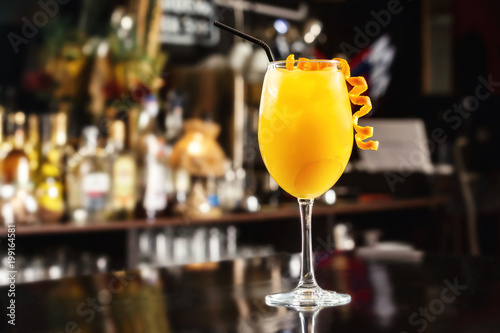 Closeup glass of orange screwdriver cocktail at bar counter background. photo