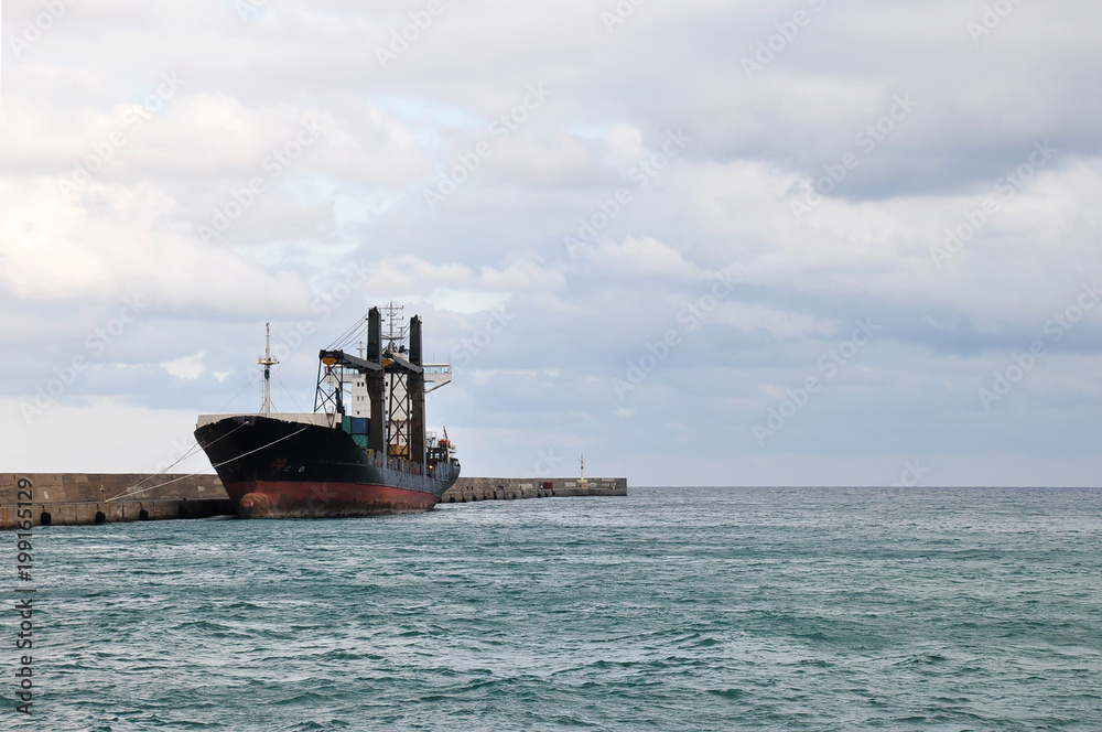 Cargo container ship on pier