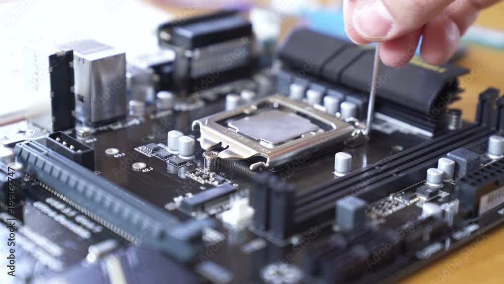 Engineer sets the CPU into the motherboard. Close up 4K shot. Engineer sets the CPU into the motherboard. Close up 4K shot.