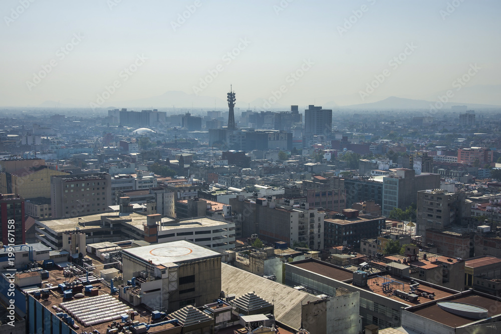 Fototapeta premium Aerial view of a neighborhood called Colonia Juarez in Mexico City, Mexico, on a sunny morning with some haze.