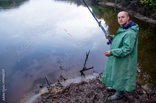 The fisherman with fishing rod. Fishing. The channel of the river Nadym. Yamal.