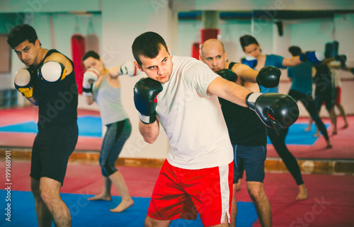 Portrait of females and males training in boxing gloves