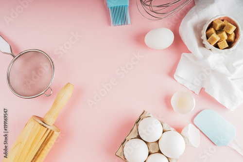Frame of food ingredients for baking on a gently pink pastel background. Cooking flat lay with copy space. Top view. Baking concept. Mockup.