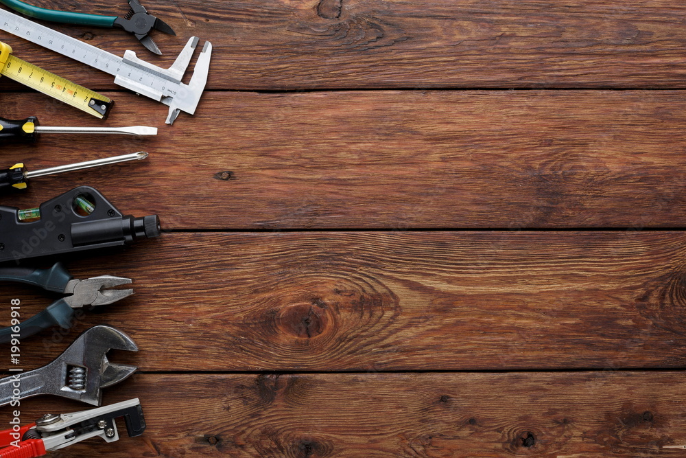 Border of repair tools on wood background with copy space Border of repair tools on wood background with copy space