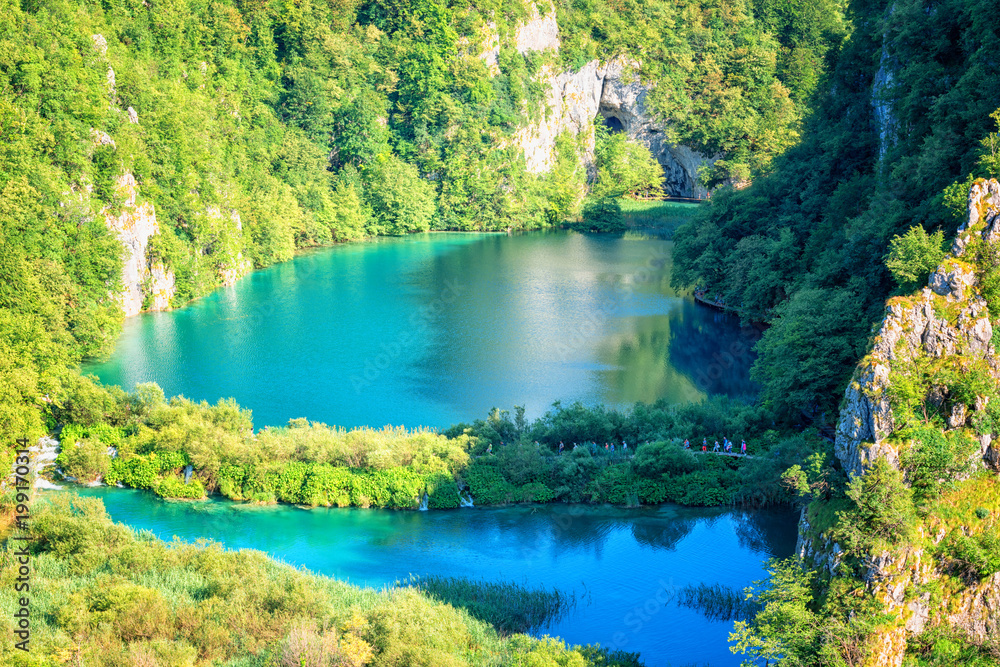 Panoramic view of waterfalls, rocks and lakes from popular tourist viewpoint in Plitvice Lakes National park. Amazing nature summer landscape, famous landmark in Croatia