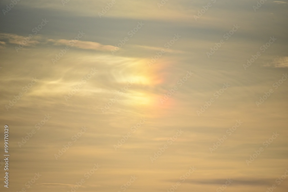 Halo in the sky. Colored rainbow on the clouds.