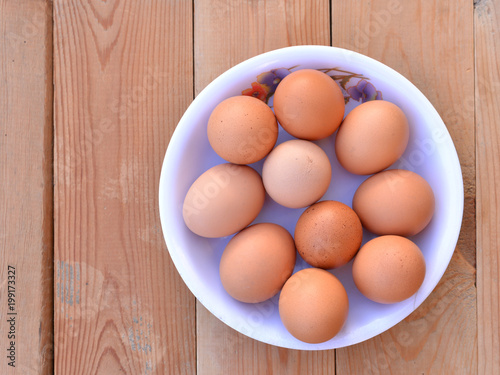 Bowl of eggs on the wooden background