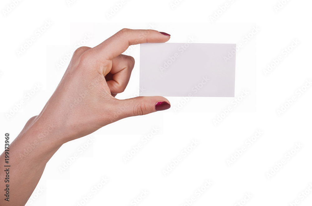 Well-groomed female hand with manicure and red lacquer holding an empty white card Well-groomed female hand with manicure and red lacquer holding an empty white card