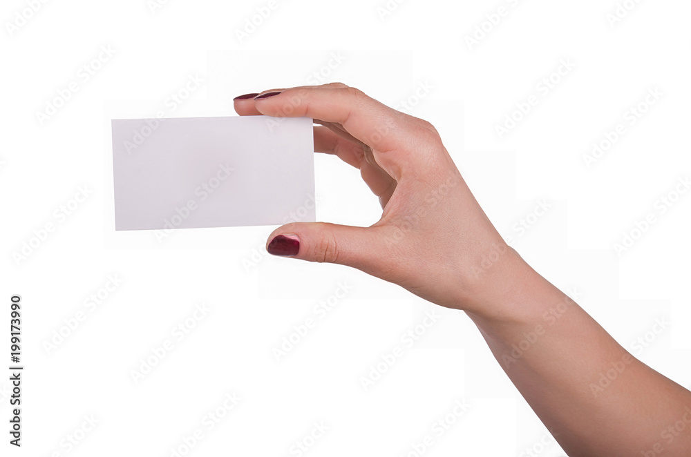 Well-groomed female hand with manicure and red lacquer holding an empty white card Well-groomed female hand with manicure and red lacquer holding an empty white card