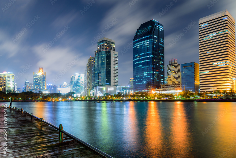 Night Cityscape of bangkok thailand with colorful of light reflection in the lake