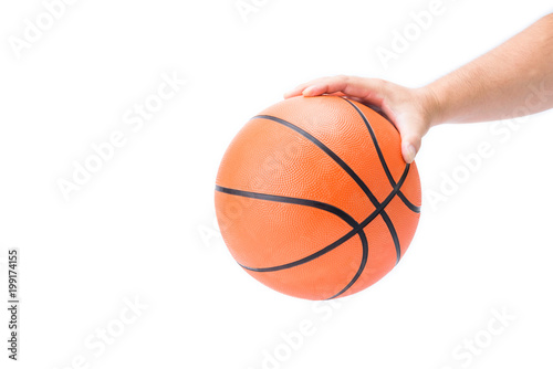 Asian man's hand is holding or palming  an orange basketball in hand isolated on white background © Vatcharachai