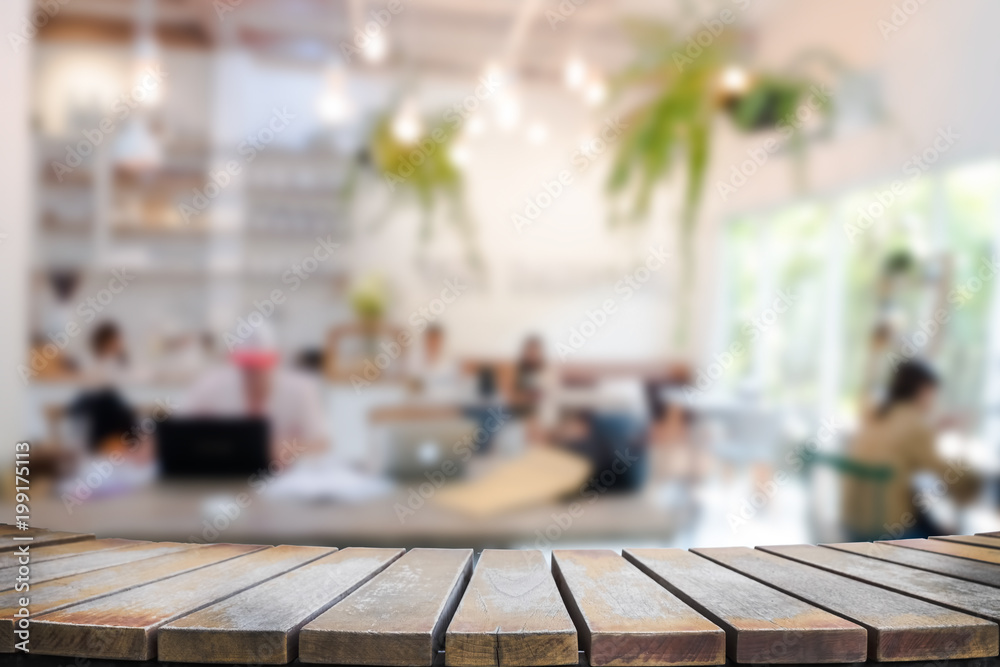 Empty wooden table space platform and blurred resturant or coffee shop background for product display montage Empty wooden table space platform and blurred resturant or coffee shop background for product display montage