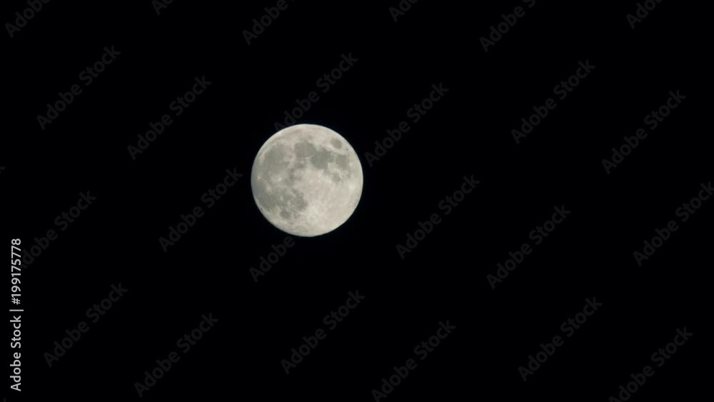Full moon moving across the night sky. Telephoto lens shot, 2,5 x speed Full moon moving across the night sky. Telephoto lens shot, 2,5 x speed