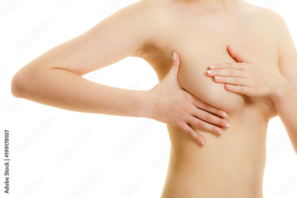 Woman examining her breasts for breast cancer Woman examining her breasts for breast cancer
