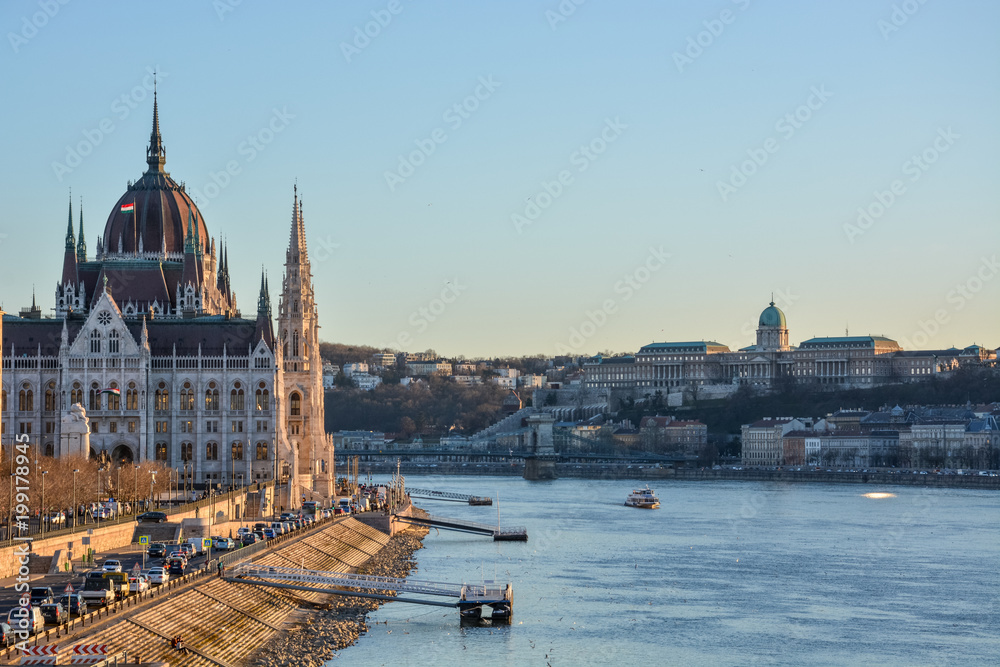 Budapest parliament and Chain Bridge and palace at the river Danube during sunset from the side