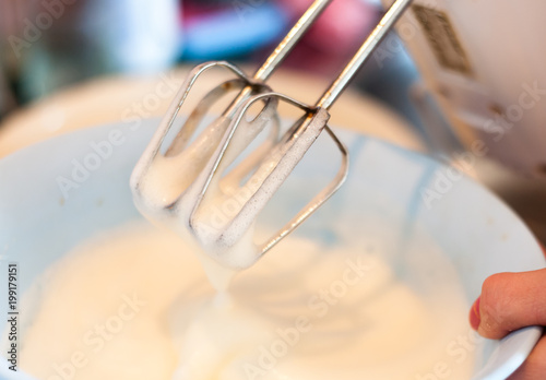 motion blurred, cream beating with electric mixer close up