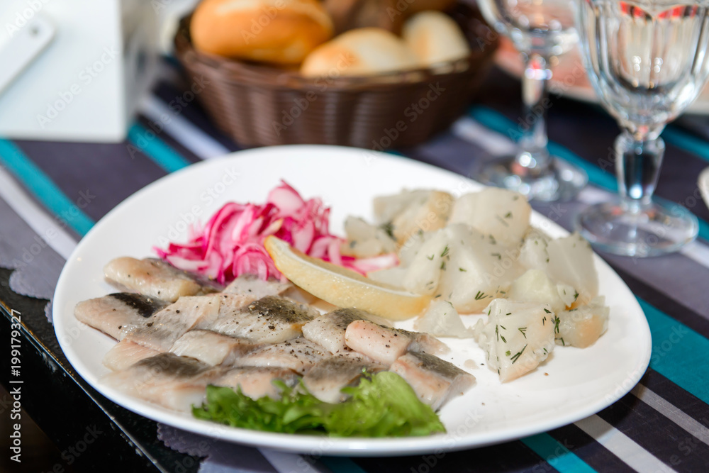 The herring and potato dish is a simple village food on the table. 
