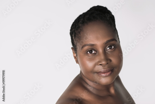 Young African woman with beautiful skin against a white background