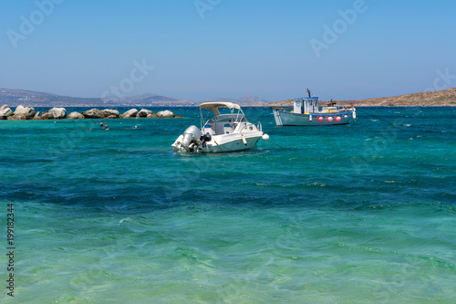 Boats on azure sea water. Agia Anna beach. Naxos island. Greece © vivoo