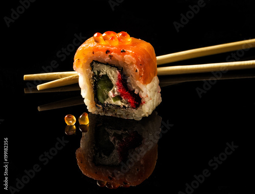 Rainbow Sushi Roll with salmon, eel, tuna, avocado, royal prawn, cream cheese Philadelphia, caviar tobica, chuka. Sushi menu Japanese food