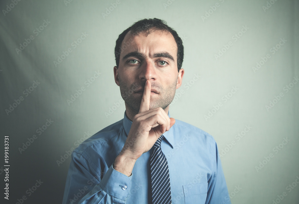 Caucasian man making silence gesture. Caucasian man making silence gesture.