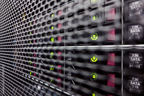 Server hard drives SATA. Internet server in datacenter close-up view. Hard drives in a computer rack photo