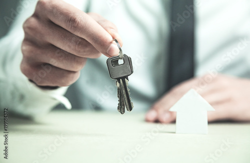 Man giving house keys. Real estate concept