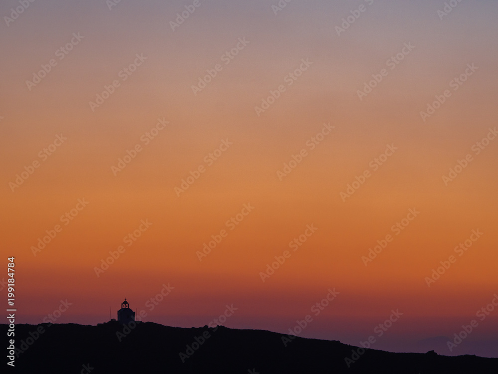 A small chapel on top of the hill at sunset