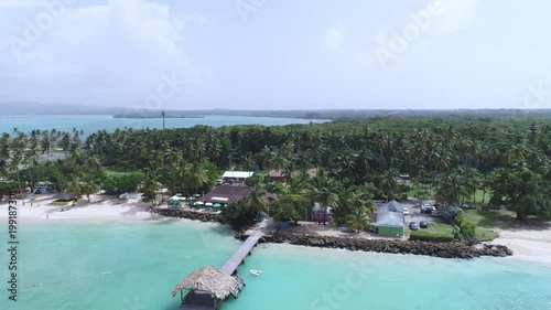 reverse reveal drone shot of a Caribbean holiday resort on the beach