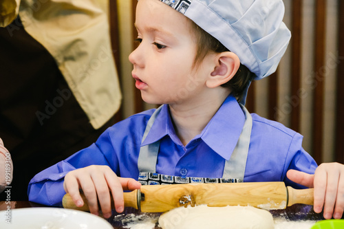Boy with chef hat preparing...