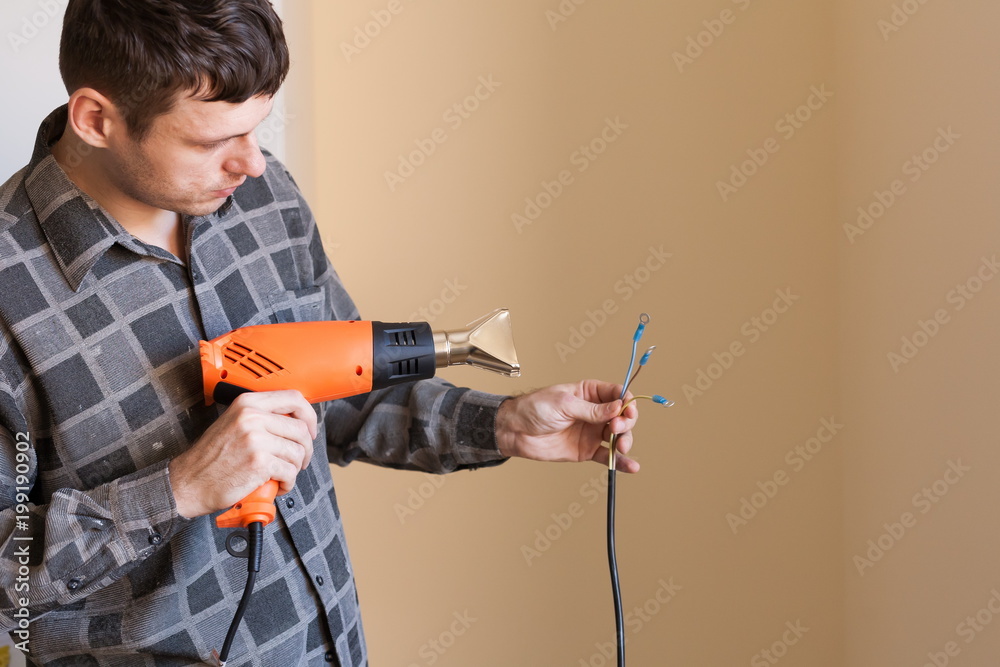 Apartment-repair. Man, wire, electric drier, close up