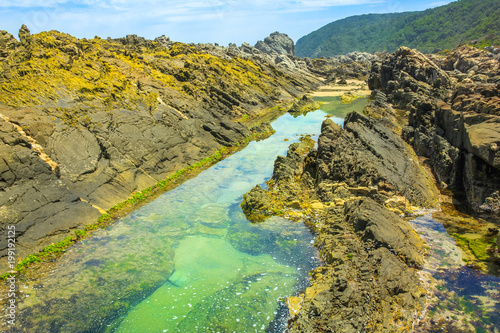 Rocks and tide pools in Tsitsikamma Nature Reserve on Garden Route in South Africa. The natural pools of the Storms River are a popular attraction in the Eastern Cape.