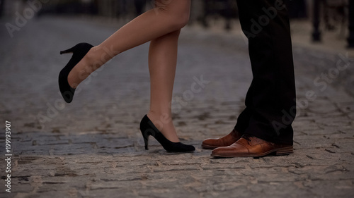 Legs of joyful girl kissing her boyfriend, partners from dating website, romance