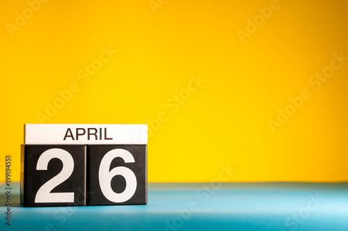 April 26th. Day 26 of april month, calendar on table with yellow background. Spring time, empty space for text