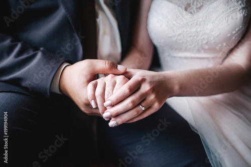 Young wedding couple holding hands