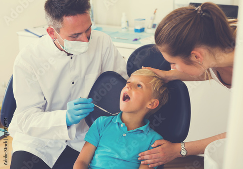 Kid with woman are visiting dentist