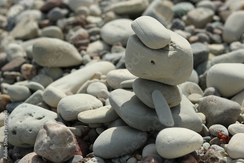 Stonefigure built on the beach bright figure, blurry background