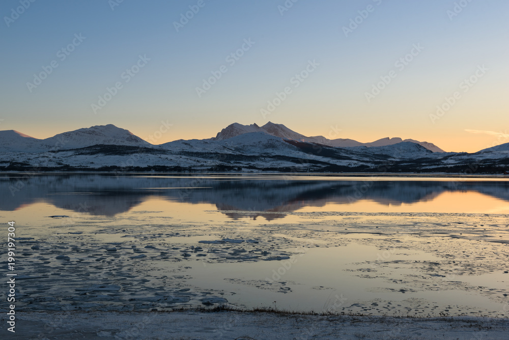 A Norwegian fjord near Tromsø covered with ice at sunset, Tromsø, Norway