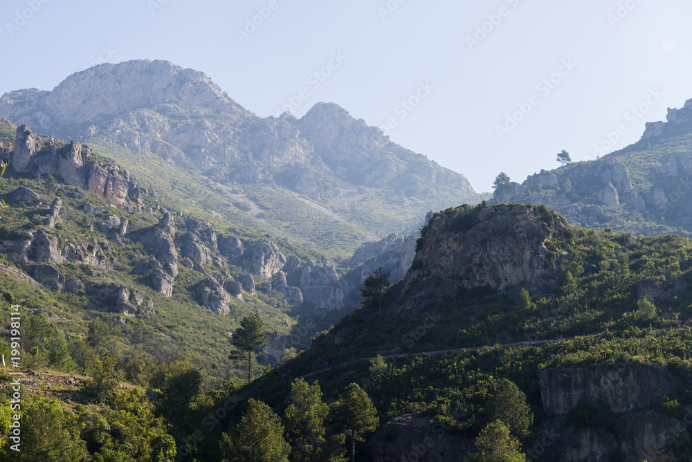 landscape image at Puertos de Beceite national park showing the beautiful rocky hills with dense vegetation and nice morning sunlight