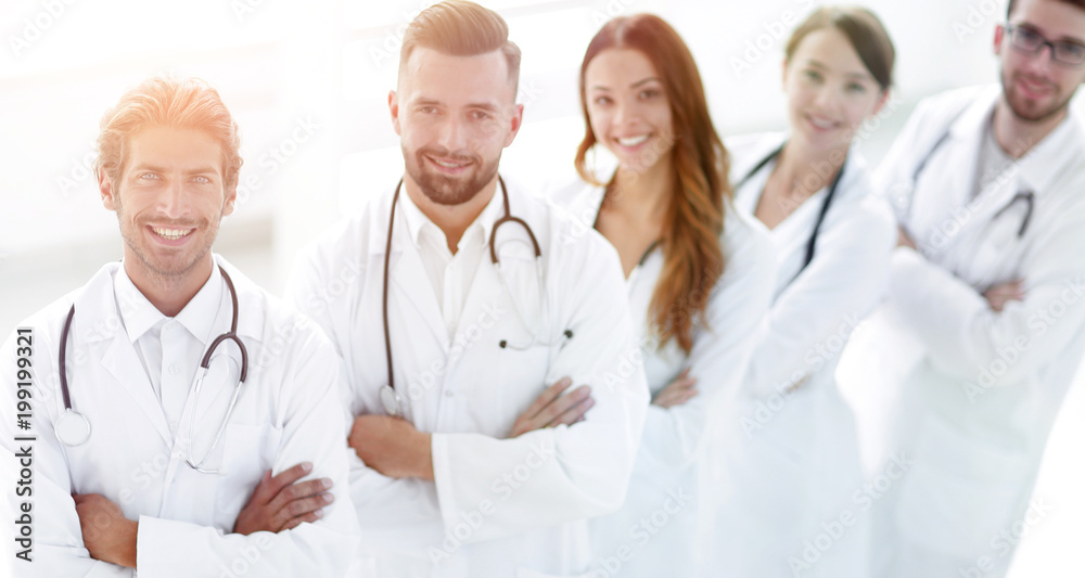 medical team standing with arms crossed on a white background medical team standing with arms crossed on a white background