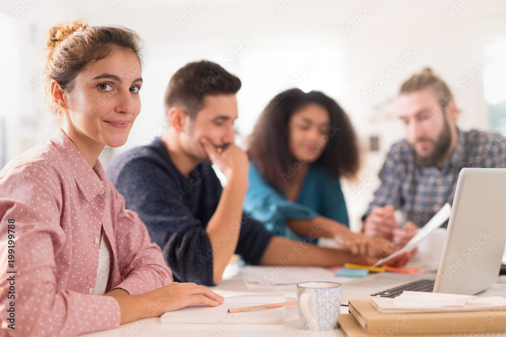 At office. Portrait of a young woman looking at the camera. At office. Portrait of a young woman looking at the camera.