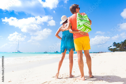 Couple wearing bright clothes on a tropical beach on Barbados
