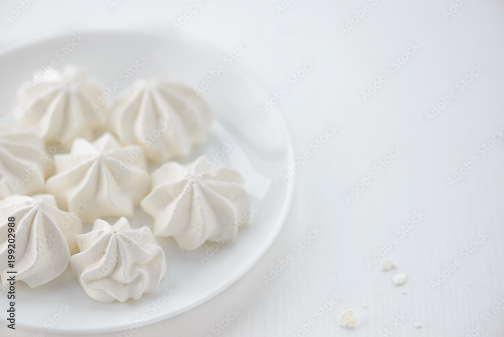 meringues in a plate on a white background